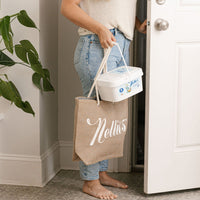 Lady holding Brown Jute Tote and bucket of Laundry Soda