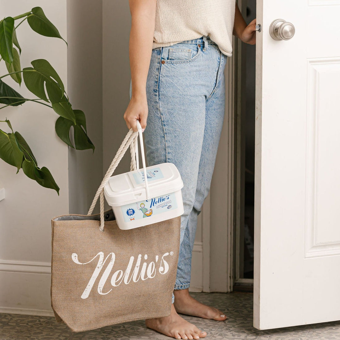 Lady carrying 200 load bucket of laundry detergent inside with tote bag