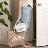 Lady carrying 200 load bucket of laundry detergent inside with tote bag