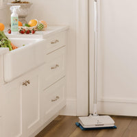Fruit and vegetable wash and fruit on counter with electric mop on floor