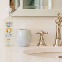 one soap water lily scent in plastic bottle on bathroom counter beside sink